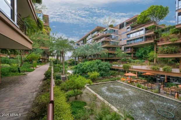 a view of a large building with a yard and plants