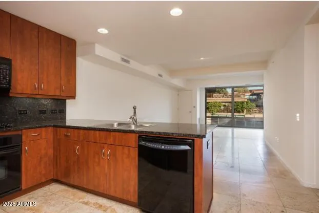 a kitchen with granite countertop a sink and cabinets