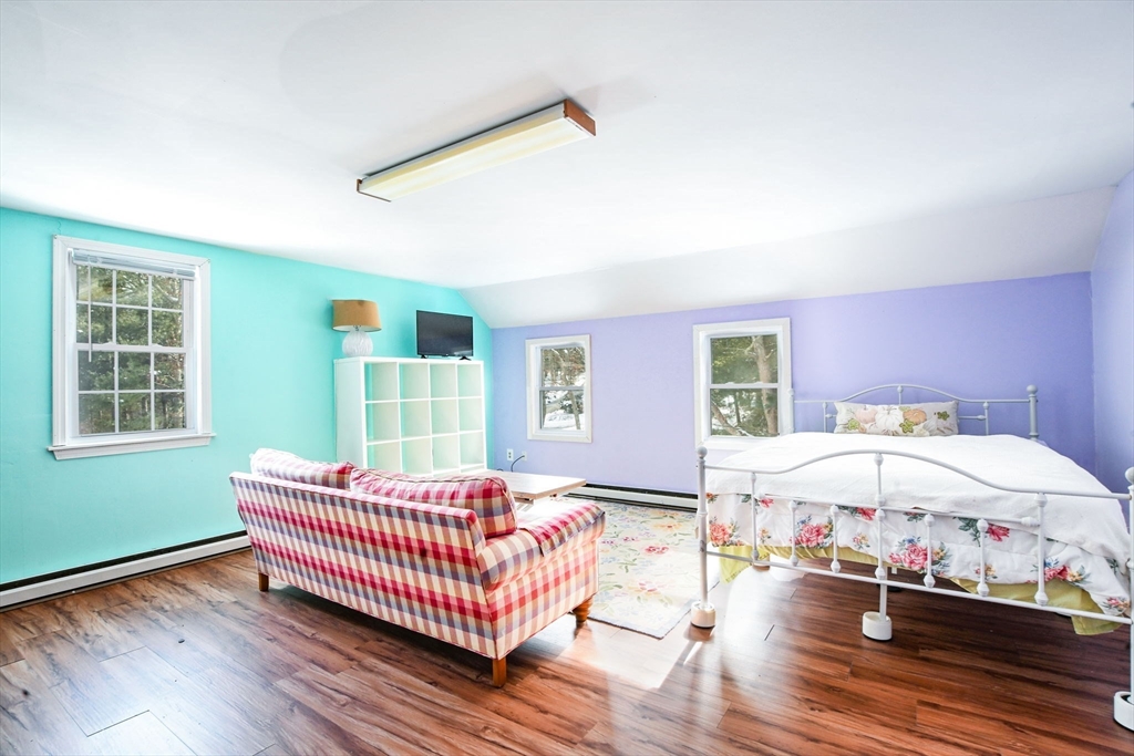 46 Service Road Sandwich, MA 02537 - Photo 16 of 35 a bedroom with a bed and wooden floor