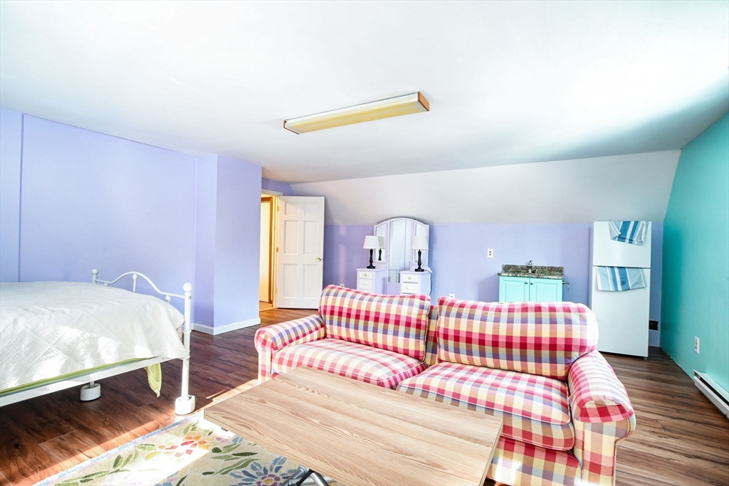 46 Service Road Sandwich, MA 02537 - Photo 18 of 35 a bedroom with a bed and wooden floor