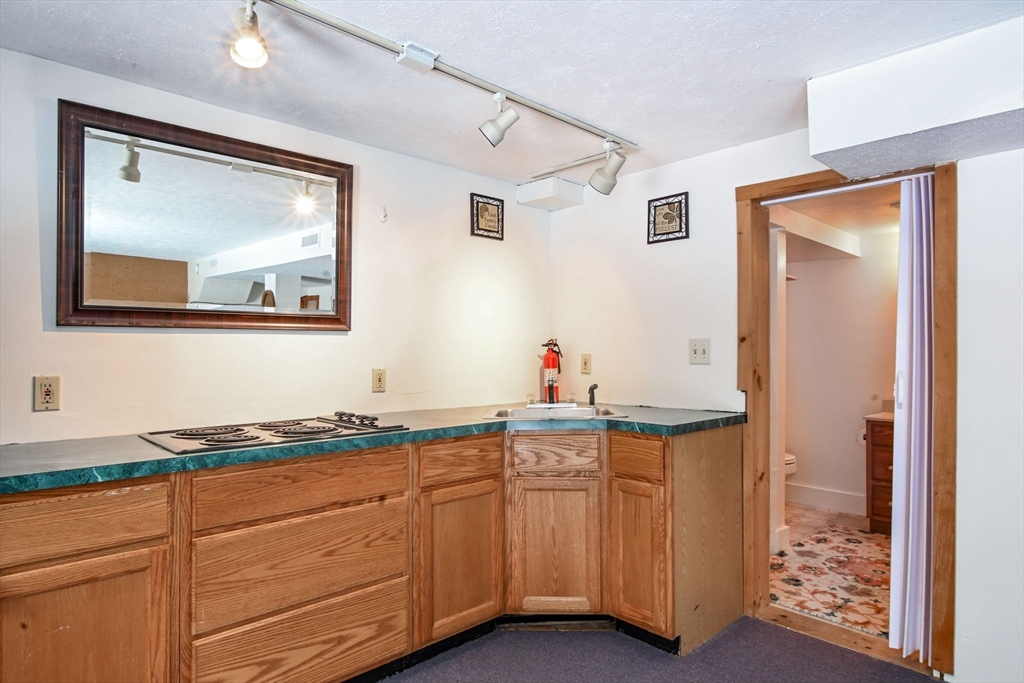 46 Service Road Sandwich, MA 02537 - Photo 26 of 35 a kitchen with stainless steel appliances granite countertop a sink and cabinets