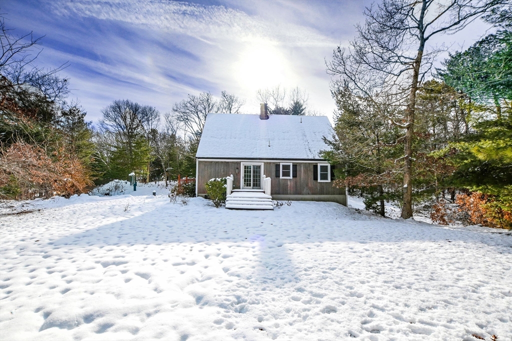 46 Service Road Sandwich, MA 02537 - Photo 4 of 35 a view of a house with a yard covered in snow