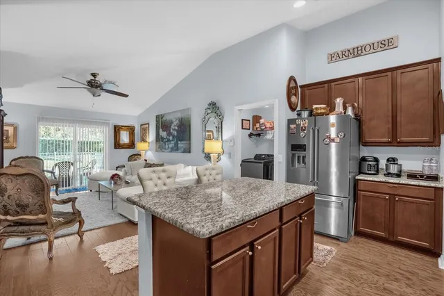 a kitchen with center island and stainless steel appliances