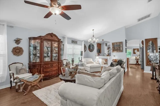 a living room with furniture fireplace and a chandelier