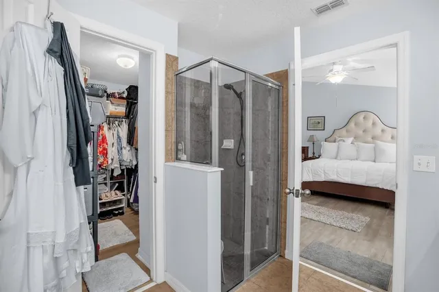 a view of walk in closet with clothes and shoes
