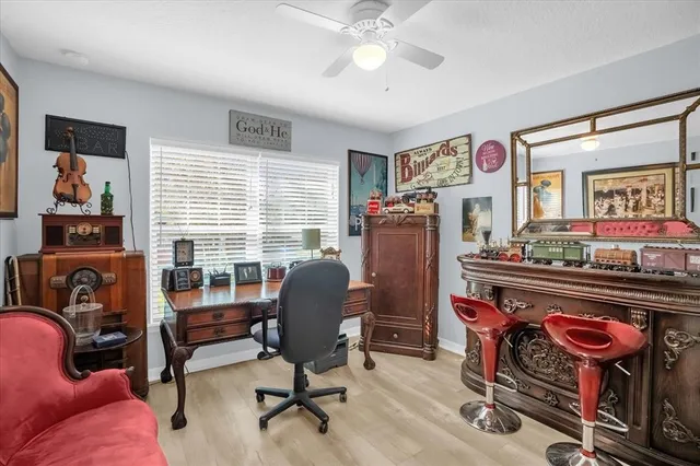 a view of a workspace with furniture and a window