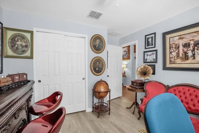a living room with furniture and a lamp
