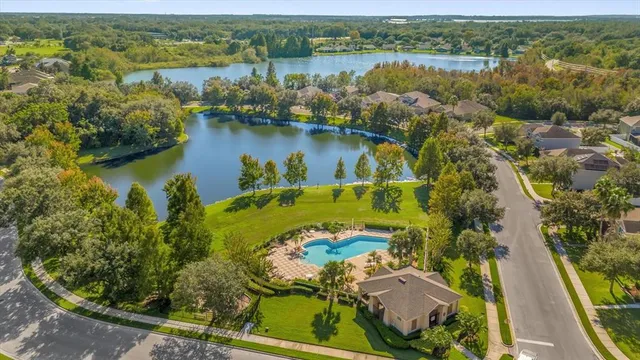 an aerial view of residential houses with outdoor space and river