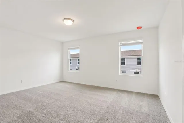 an empty room with a empty space and windows