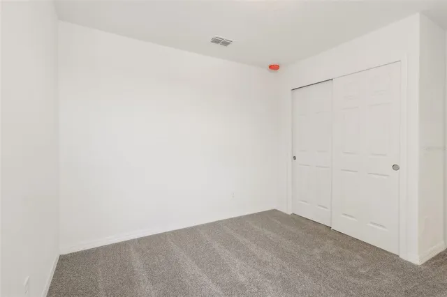a bathroom with a granite countertop toilet a sink and a bathtub