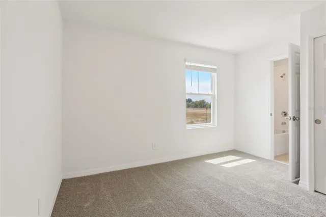 a backyard of a house with barbeque oven table and chairs