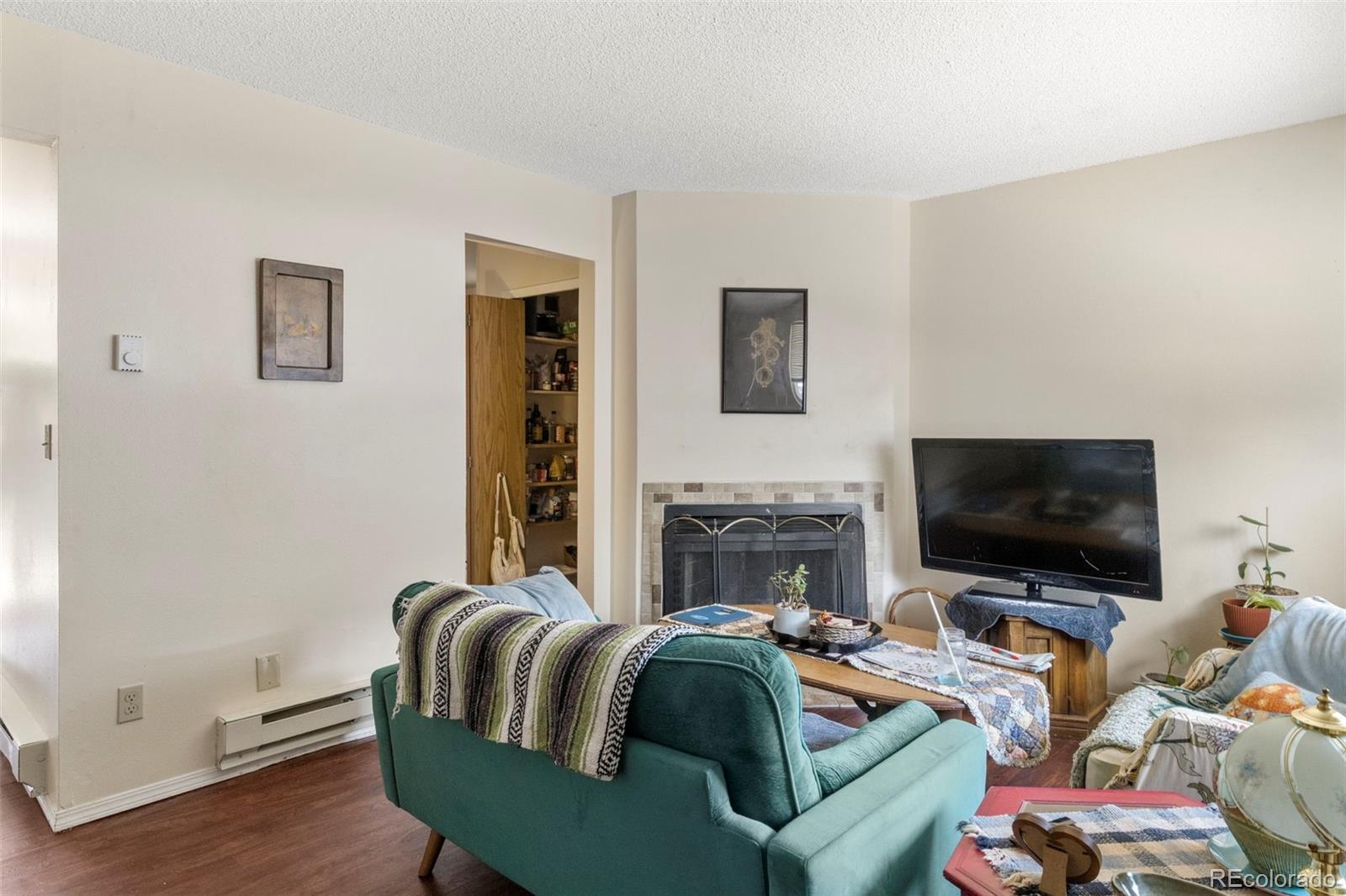 567-579 Winnie Way Colorado Springs, CO 80904 - Photo 17 of 32 a living room with furniture and a flat screen tv