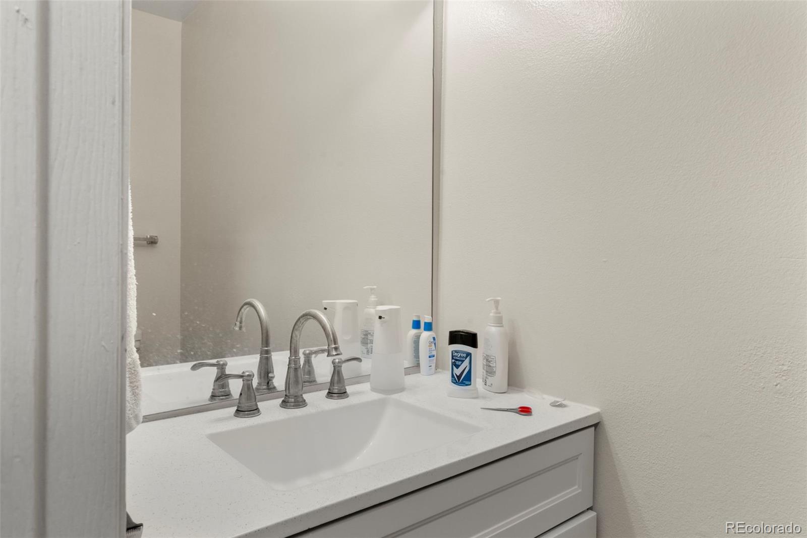 567-579 Winnie Way Colorado Springs, CO 80904 - Photo 19 of 32 a bathroom with a sink and a mirror