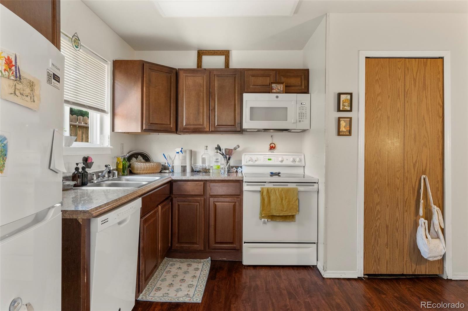 567-579 Winnie Way Colorado Springs, CO 80904 - Photo 8 of 32 a kitchen with a sink a stove and cabinets