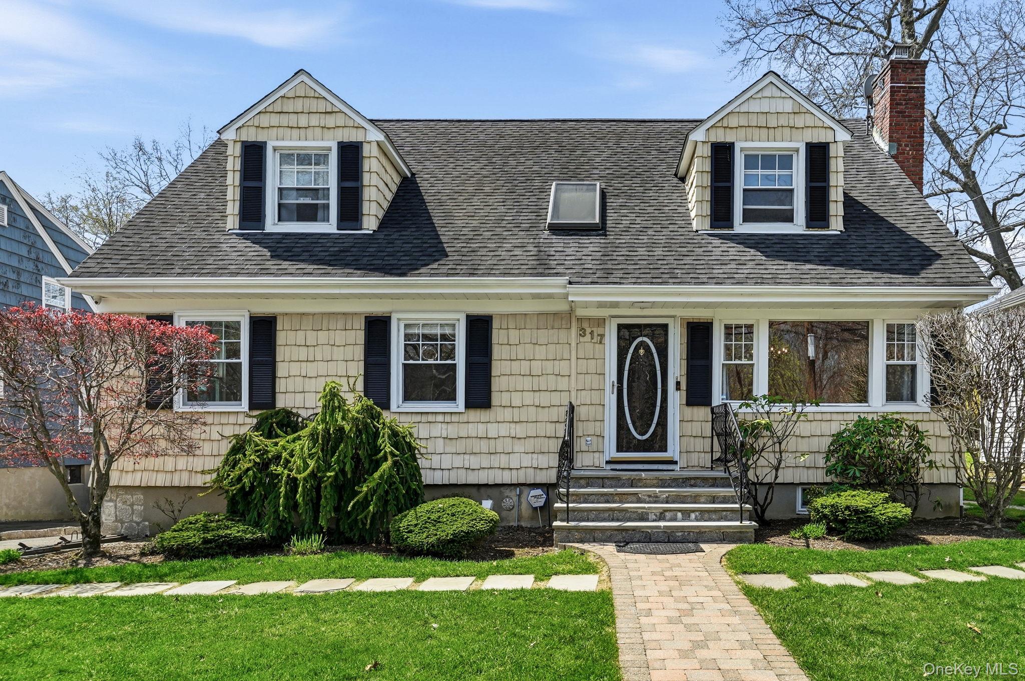 317 Hornidge Road Mamaroneck, NY 10543 - Photo 1 of 21 a front view of a house with a yard
