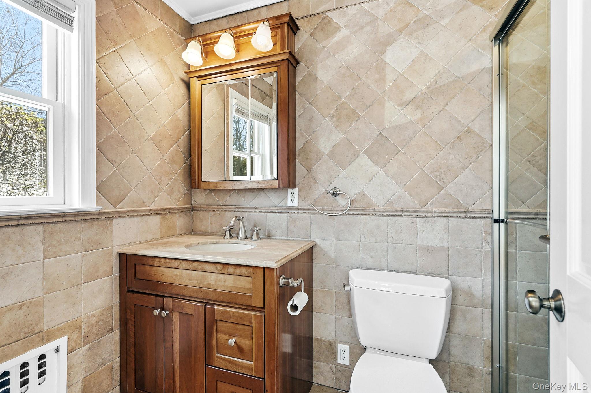 317 Hornidge Road Mamaroneck, NY 10543 - Photo 13 of 21 a bathroom with a toilet sink and mirror