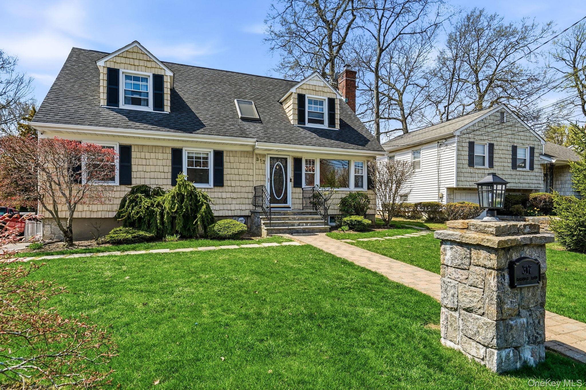 317 Hornidge Road Mamaroneck, NY 10543 - Photo 2 of 21 a front view of a house with a garden