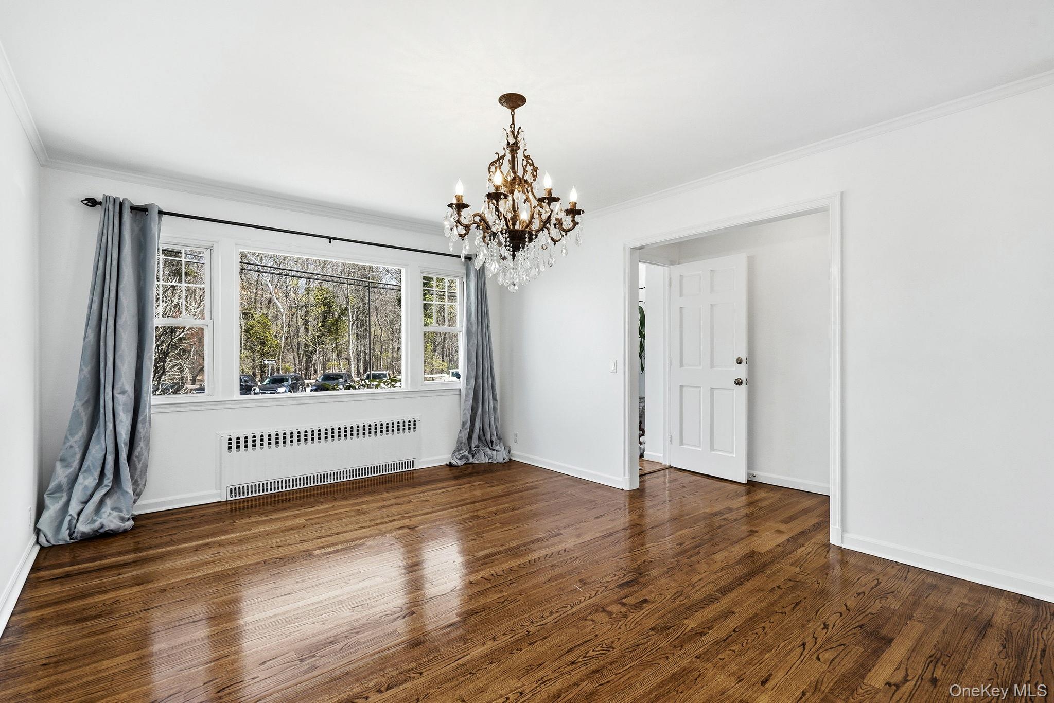 317 Hornidge Road Mamaroneck, NY 10543 - Photo 4 of 21 wooden floor in an empty room with a window