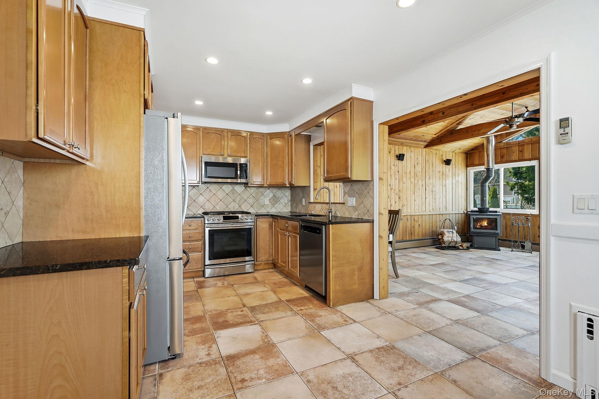 317 Hornidge Road Mamaroneck, NY 10543 - Photo 6 of 21 a kitchen with stainless steel appliances granite countertop a refrigerator and a stove top oven