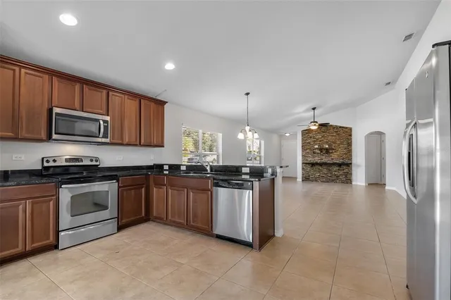 a kitchen with a sink cabinets and stainless steel appliances