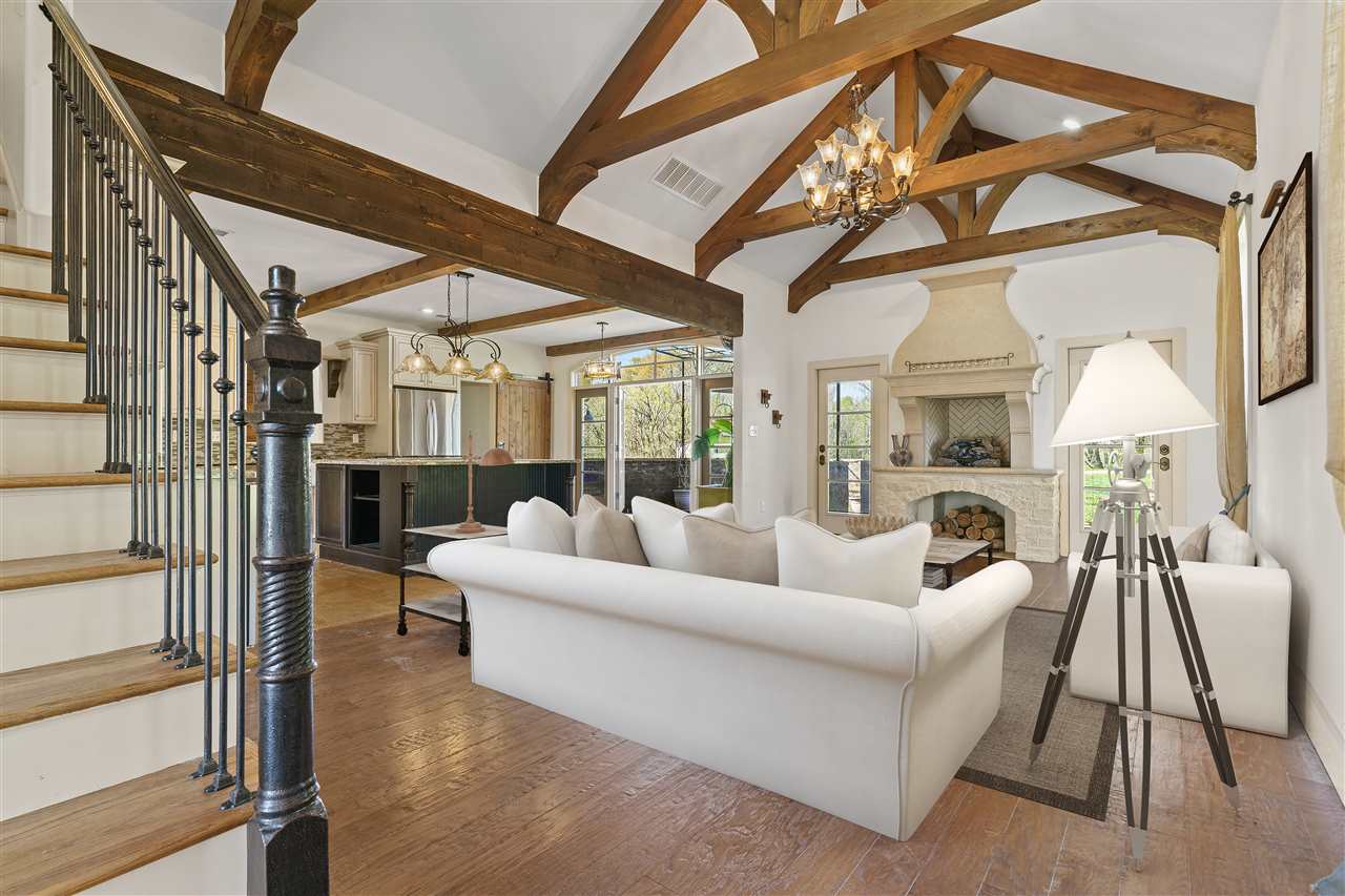 3887 Lucy Road Millington, TN 38053 - Photo 4 of 25 The Spacious 21x14 GREAT ROOM features Soaring 14 ft Wood-Beamed Smooth Ceiling and Fabulous Custom Fireplace - open to the Kitchen! Photo virtually staged.
