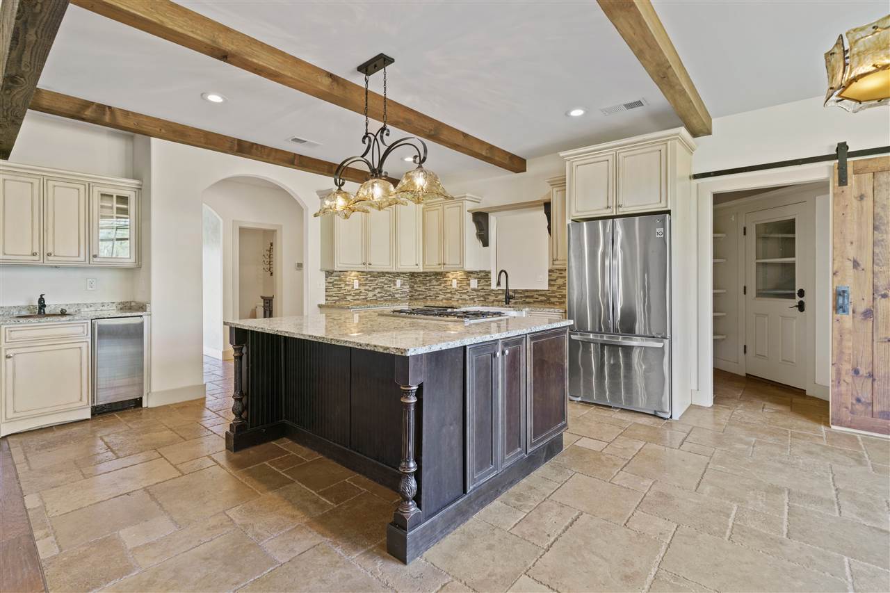 3887 Lucy Road Millington, TN 38053 - Photo 5 of 25 FABULOUS KITCHEN with Custom Tile Floor, Granite, Glass Tile Backsplash, Gorgeous Island with Breakfast Bar, 16 Cabinets, Beverage Center, Icemaker, GE Profile Convection Oven, 5-Burner Gas Range, Pantry, MORE!