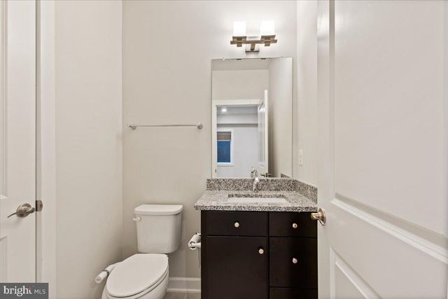 a bathroom with a sink vanity and toilet