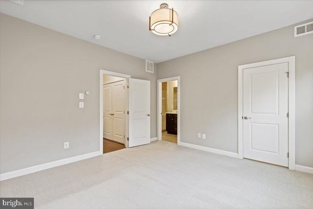 an empty room with a empty space and windows