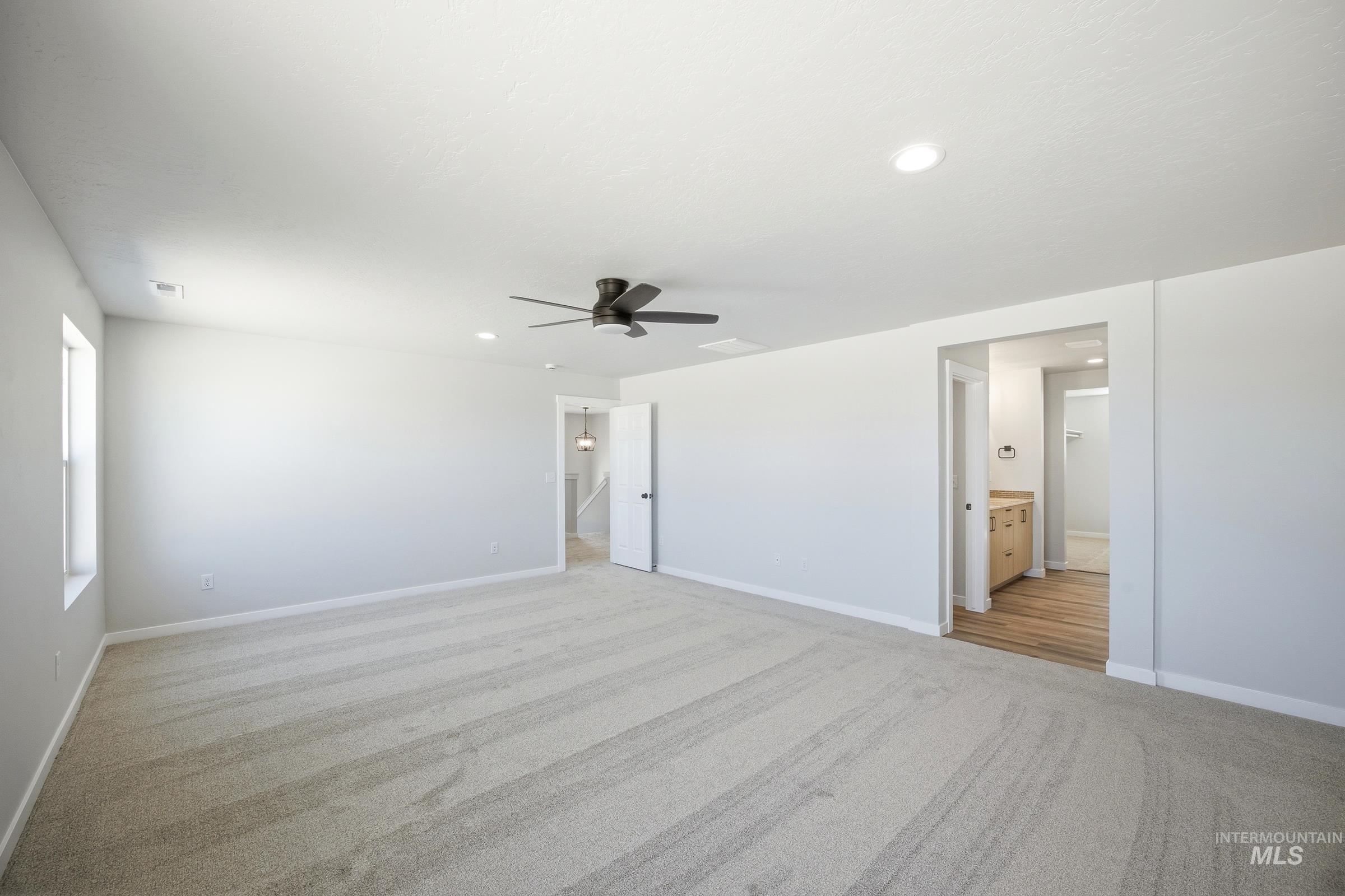 12841 Decatur Street Nampa, ID 83651 - Photo 26 of 30 Spacious room featuring light-toned carpeting, a ceiling fan, recessed lighting, and a window