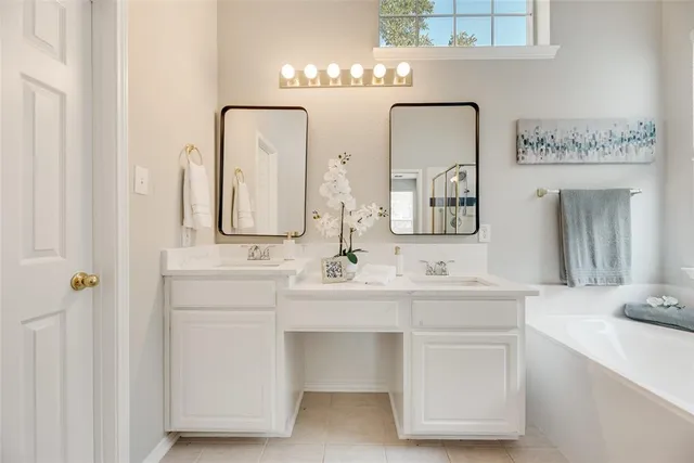 a bathroom with double vanity sinks and a mirror