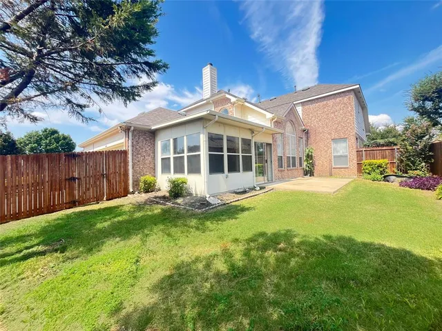 a view of a house with a backyard and a patio