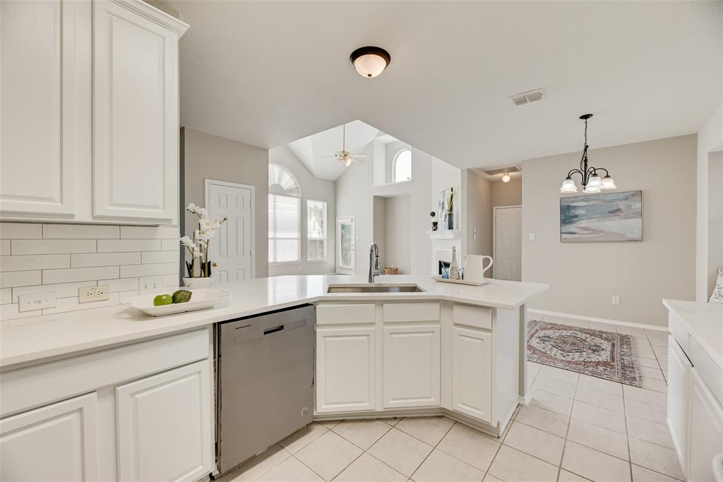 4404 Ridge Point Lane Plano, TX 75024 - Photo 7 of 18 a kitchen with a sink and cabinets