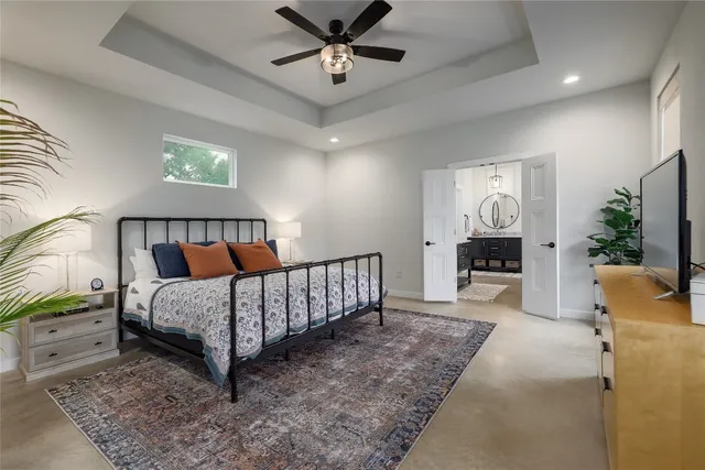 a bed room with a bed and a chandelier