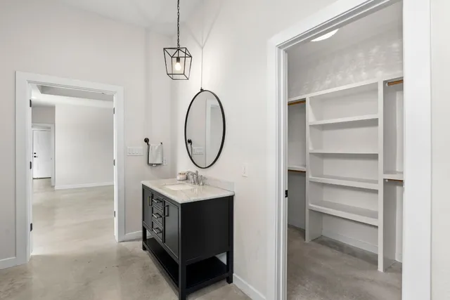 a bathroom with a toilet a sink and a mirror