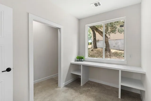 a view of room with window and furniture