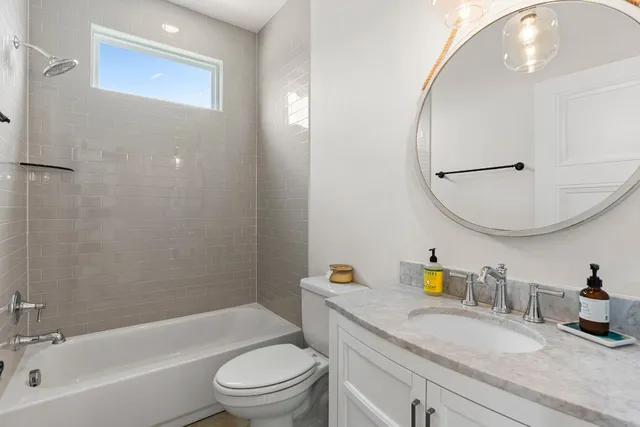 a bathroom with a sink a toilet and a mirror