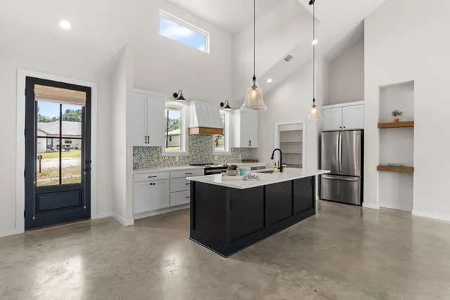 a large kitchen with a large window and stainless steel appliances