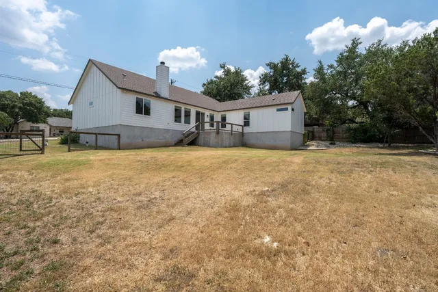 an aerial view of a house with garden space and swimming pool