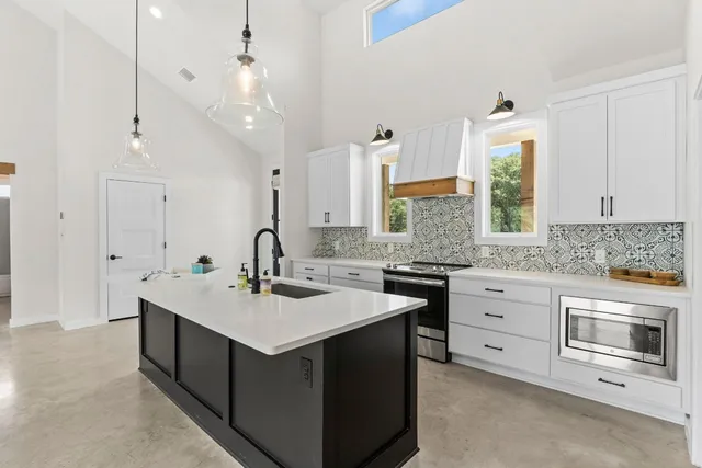 a kitchen with a sink stove and cabinets