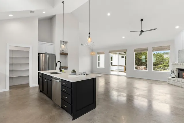 a kitchen with stainless steel appliances granite countertop a sink stove and a refrigerator