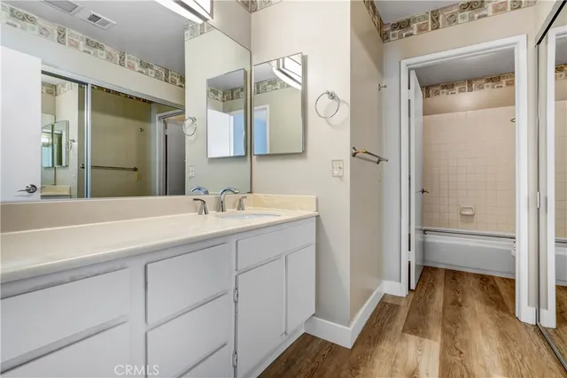 a bathroom with a sink a mirror and a shower