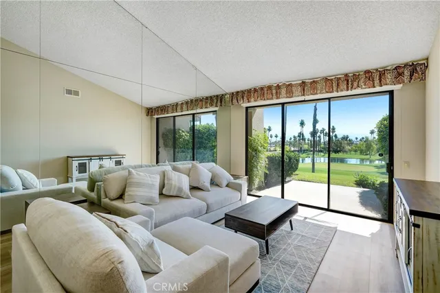 a living room with furniture and a floor to ceiling window