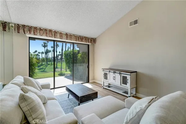 a living room with furniture and a large window