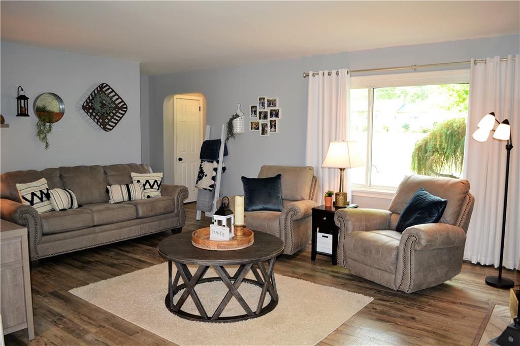 1515 Butler Road Worthington, PA 16262 - Photo 12 of 25 The spacious living room has a large picture window, LVP flooring, and a gas fireplace.