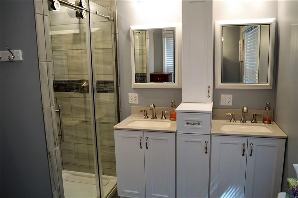 1515 Butler Road Worthington, PA 16262 - Photo 16 of 25 Soft close cabinets, a double sink, and a ceramic tile shower.