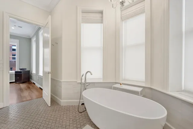 a spacious bedroom with a bed and a flat screen tv