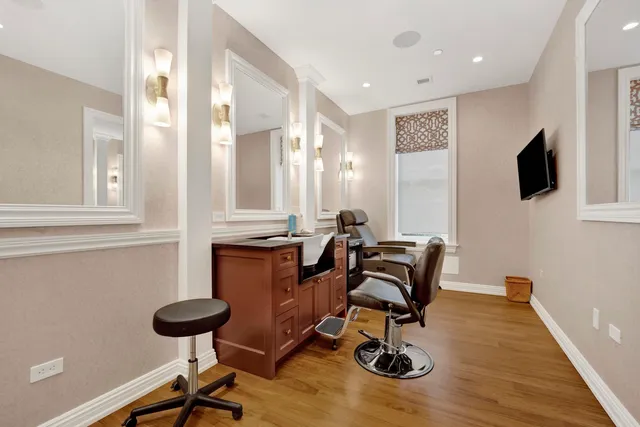 a bathroom with a tub sink and mirror