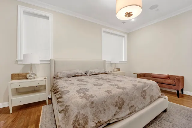 a bedroom with two beds and lamps