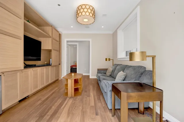 a room with a couch a rug and gym equipment