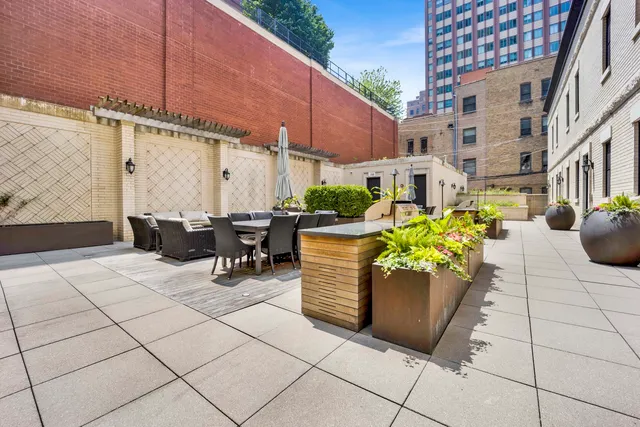 a view of a patio with couches and potted plants